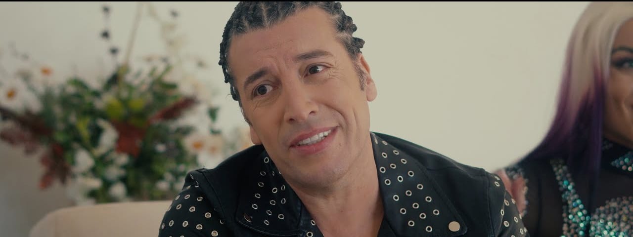 Leo Rey's cumbia catalogue comes to Adelaide with guest DJ Mars - Man in studded black jacket smiles at camera in indoor setting with potted plants visible.