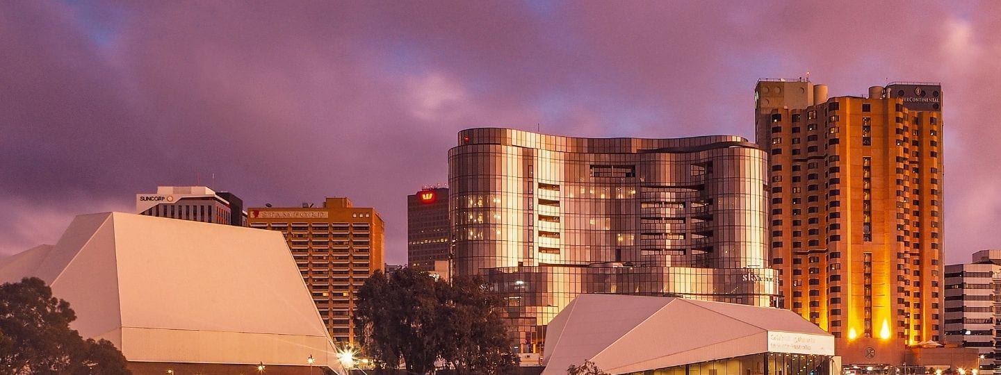 Adelaide Festival Centre - Modern cultural buildings and high-rise residential towers illuminate the Adelaide riverbank at twilight.
