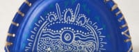 Melanie Koolmatrie’s Mardawi Bag Making - Blue semi-circular handmade bag with white Indigenous dot painting design and woven handle.