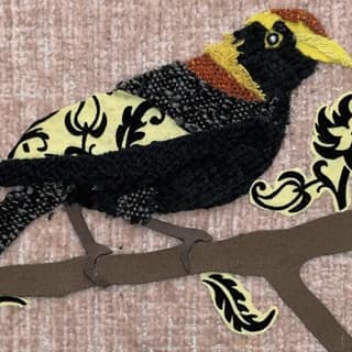 Oscar Arrais - Black and gold decorative bird perched on a branch with stylised floral motifs.