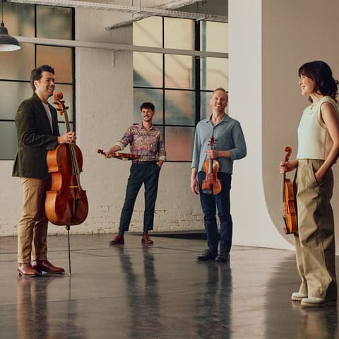 Australian String Quartet with Julian Smiles - Four musicians with string instruments and a conductor rehearse in a bright studio space at UKARIA Cultural Centre.