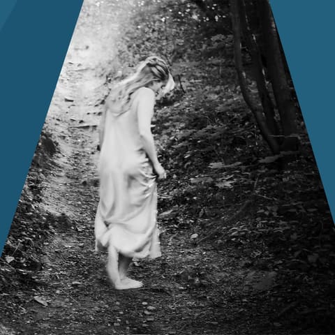 Chamberfest Concert Two | Dead Poets Society - Person in white clothing clinging to a textured tree trunk against a clear blue sky.