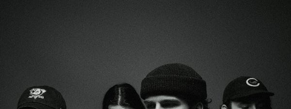 Dear Seattle Regional Australian Tour - Four band members in casual wear pose against a dark background in black and white.