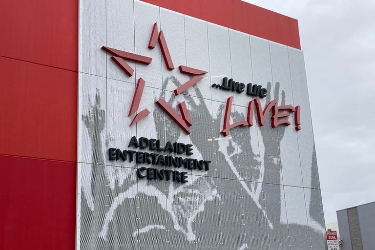 Adelaide Entertainment Centre Arena - Red and white building facade displays Adelaide Entertainment Centre signage with artistic graphic design.