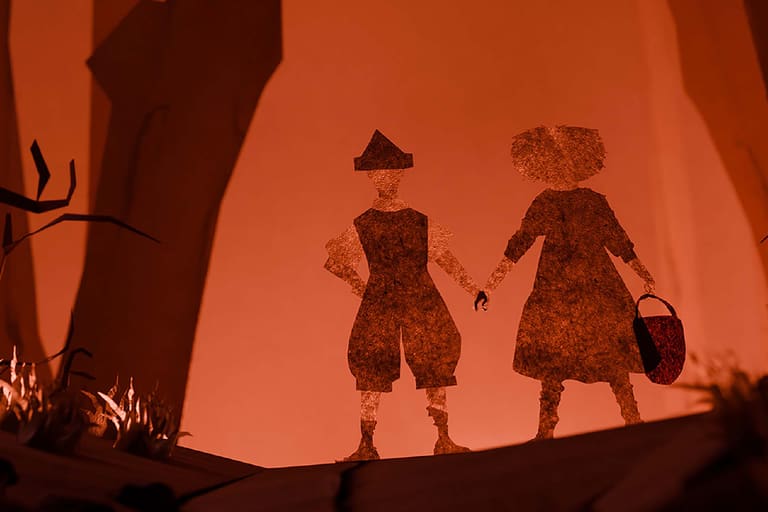 Two silhouetted figures in period costume stand together against a warm orange backdrop in a stylised theatrical scene.