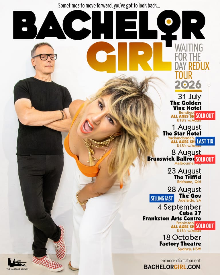 A man in glasses and black shirt stands beside a woman with blonde hair in an orange top against a white background, with tour dates listed.