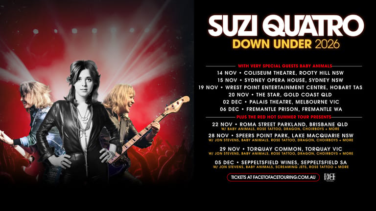 Suzi Quatro poses with a guitar against a red stage-lit background, promoting her Down Under 2025 Australian tour dates.