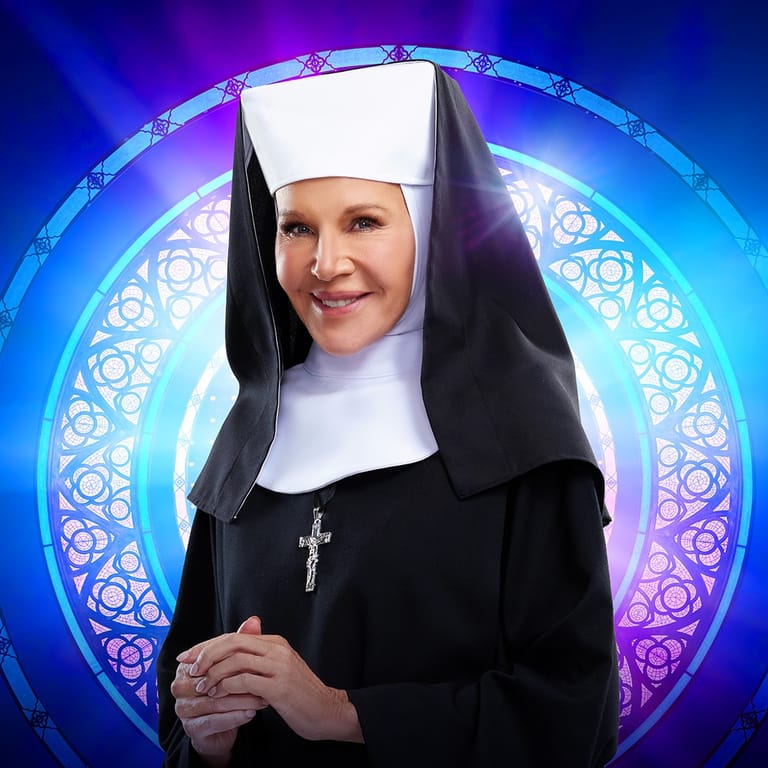 Person in nun costume with white coif and black veil stands against vibrant blue and purple glowing circular backdrop.