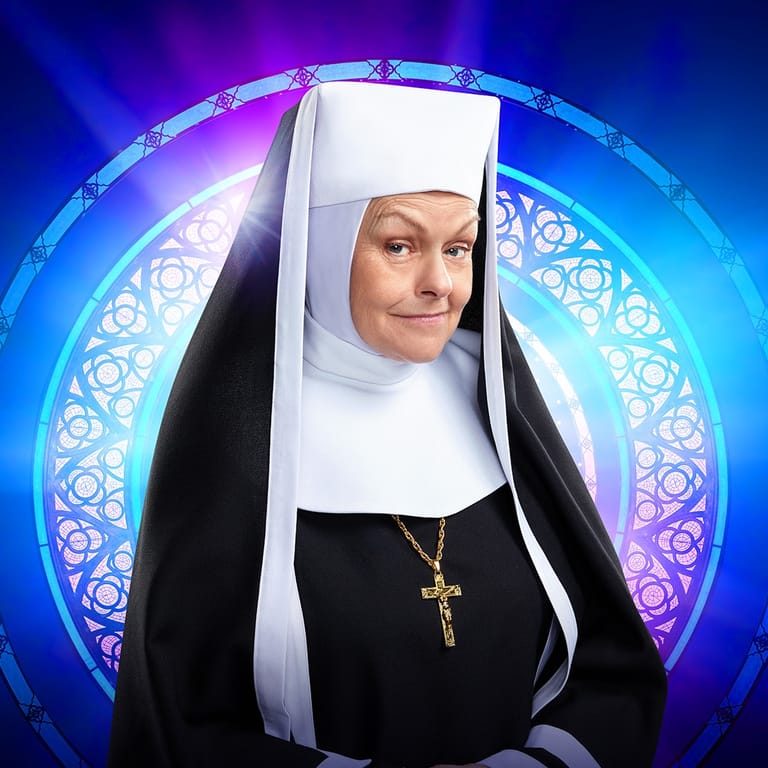 Performer dressed as a nun against a glowing circular backdrop with blue and purple lighting.