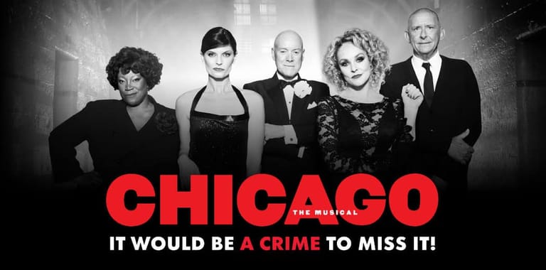 Five performers in formal black attire stand against a grey backdrop with red "CHICAGO" text and tagline below.