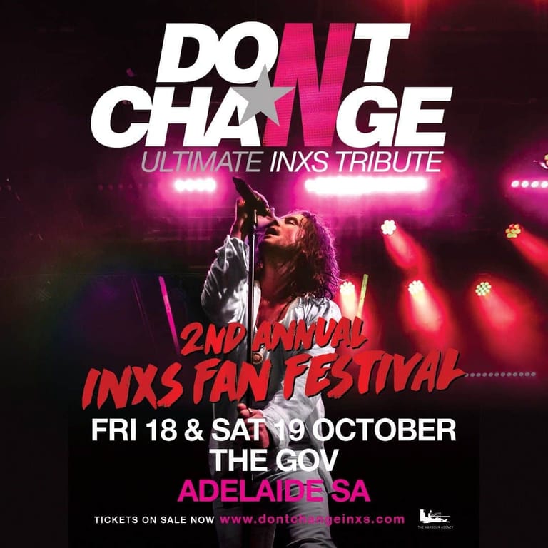 Performer in leather jacket singing under pink stage lights during Don't Change, an INXS tribute show.