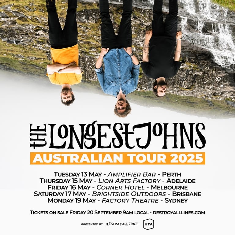 Three people upside-down with legs in the air against a brick wall backdrop for The Longest Johns Australian Tour 2025.