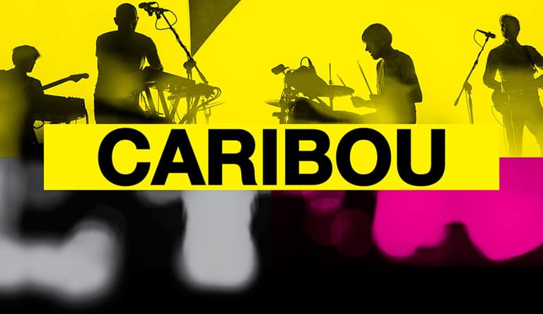 Four band members silhouetted against bright yellow and magenta stage lighting, performing live.