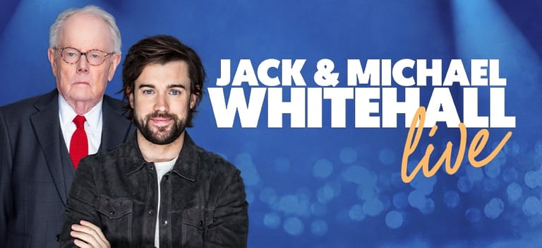 Two men stand against a blue bokeh backdrop with "Jack & Michael Whitehall Live" text displayed.