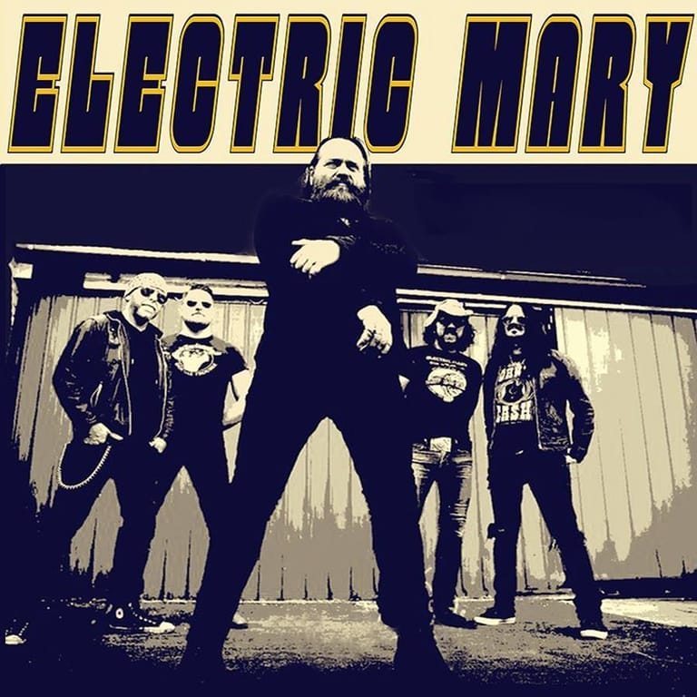 Four musicians in dark clothing stand posed against an industrial backdrop with "ELECTRIC MARY" text above in bold yellow lettering.