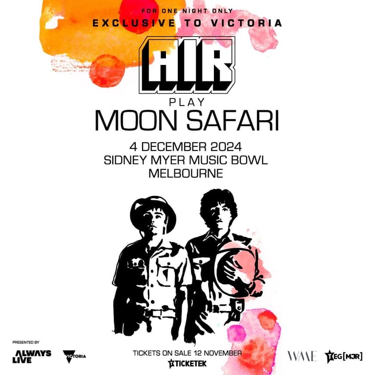 Two band members in dark jackets pose against an orange and pink floral graphic design for AIR's Moon Safari play at Sidney Myer Music Bowl.