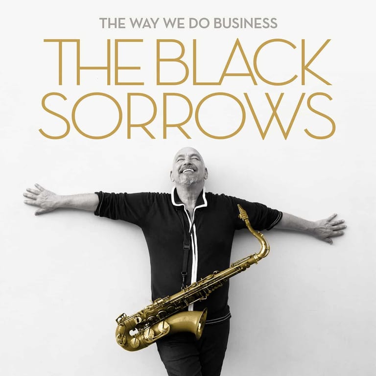 Musician in black shirt with arms outstretched, holding a saxophone, against white background with band name above.