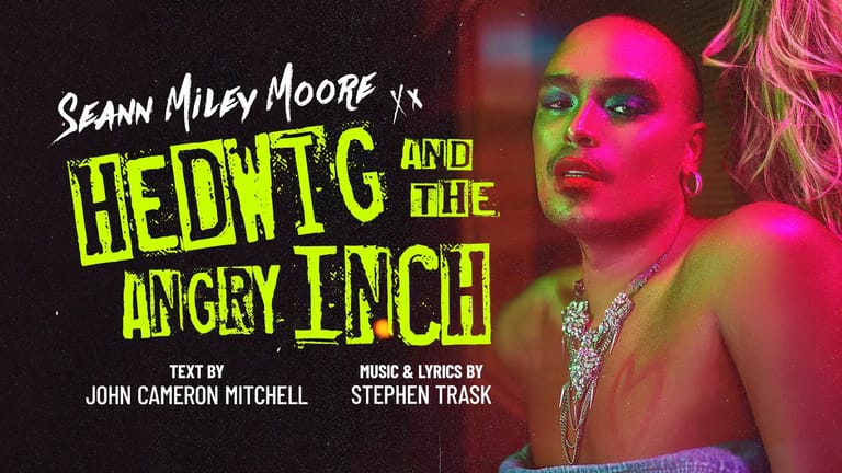 Performer with neon green and pink face paint against stage lighting, theatrical promotional image for Hedwig and the Angry Inch.