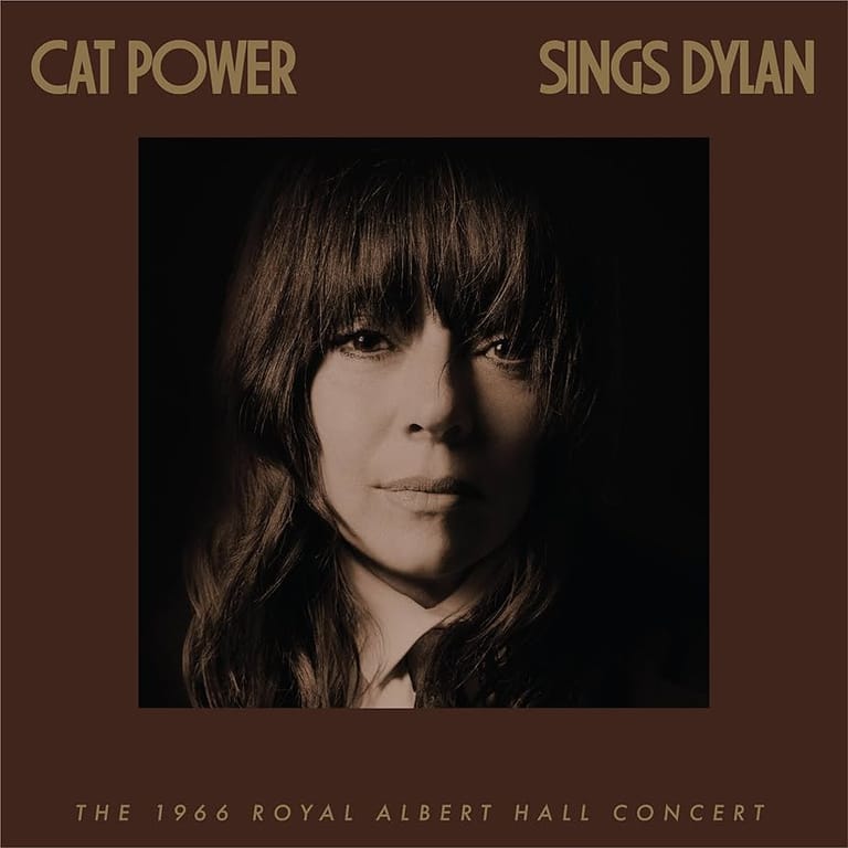 Portrait of a woman with long dark hair and fringe against a dark background, album cover for Cat Power Sings Dylan.
