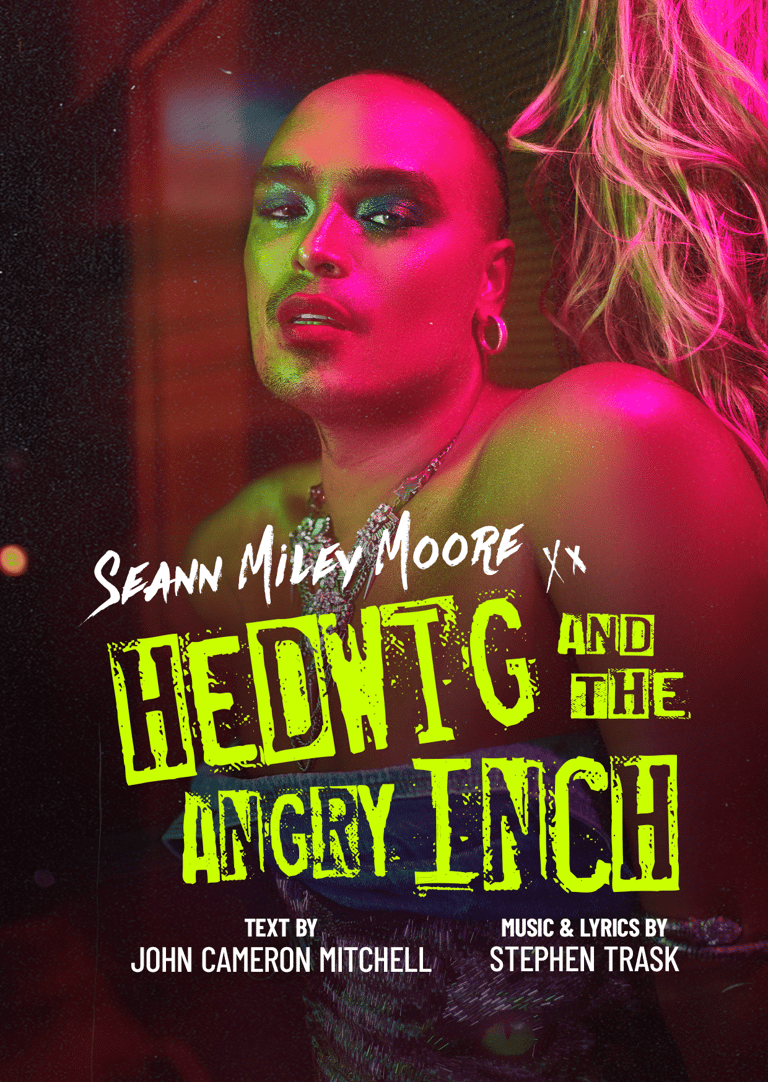 Person in vibrant neon pink and green stage lighting for Hedwig and the Angry Inch theatre production.
