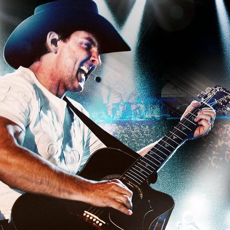 Male guitarist in cowboy hat performing with microphone, holding black electric guitar on stage.