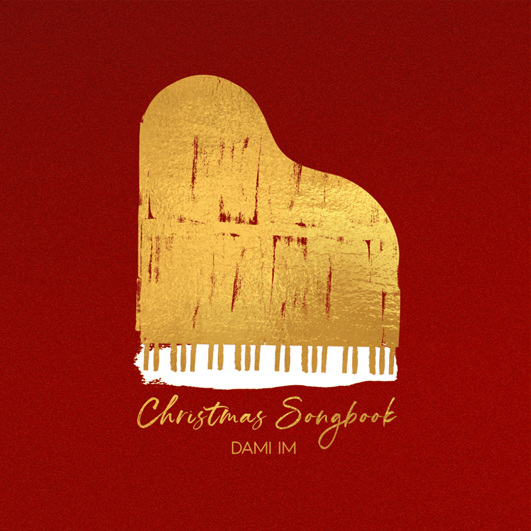 Gold piano silhouette with keyboard detail on deep red background, titled "Christmas Songbook" by Dami Im.