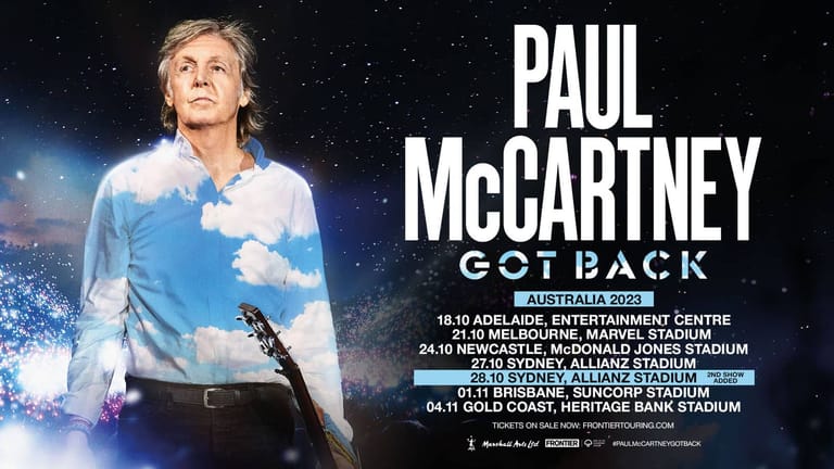 Paul McCartney stands against a starlit sky backdrop on a concert tour promotional poster.