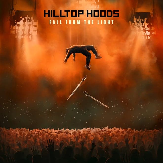 Silhouetted figure suspended above a crowd in orange haze with raised hands during Hilltop Hoods tour.
