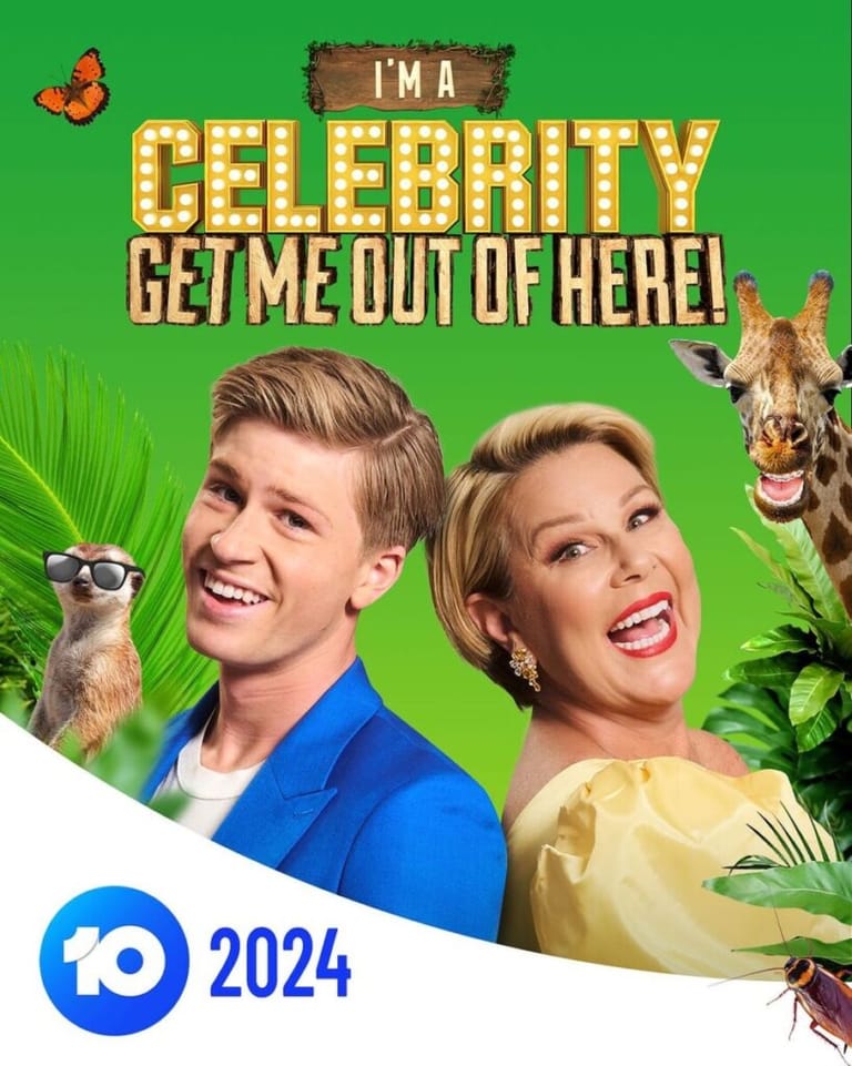 Two smiling hosts pose with tropical animals against a bright green background for I'm a Celebrity Get Me Out of Here 2024.