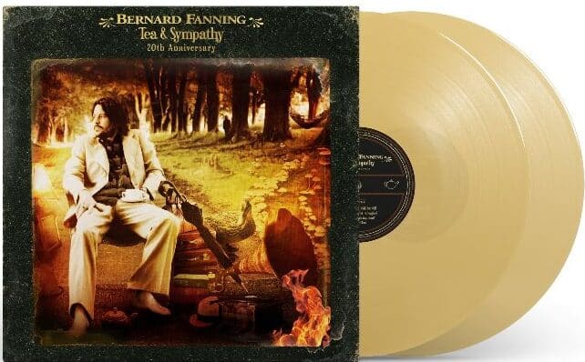 Cream-coloured vinyl record of Bernard Fanning's "Tea & Sympathy" 25th Anniversary album featuring a man seated in a forest setting.