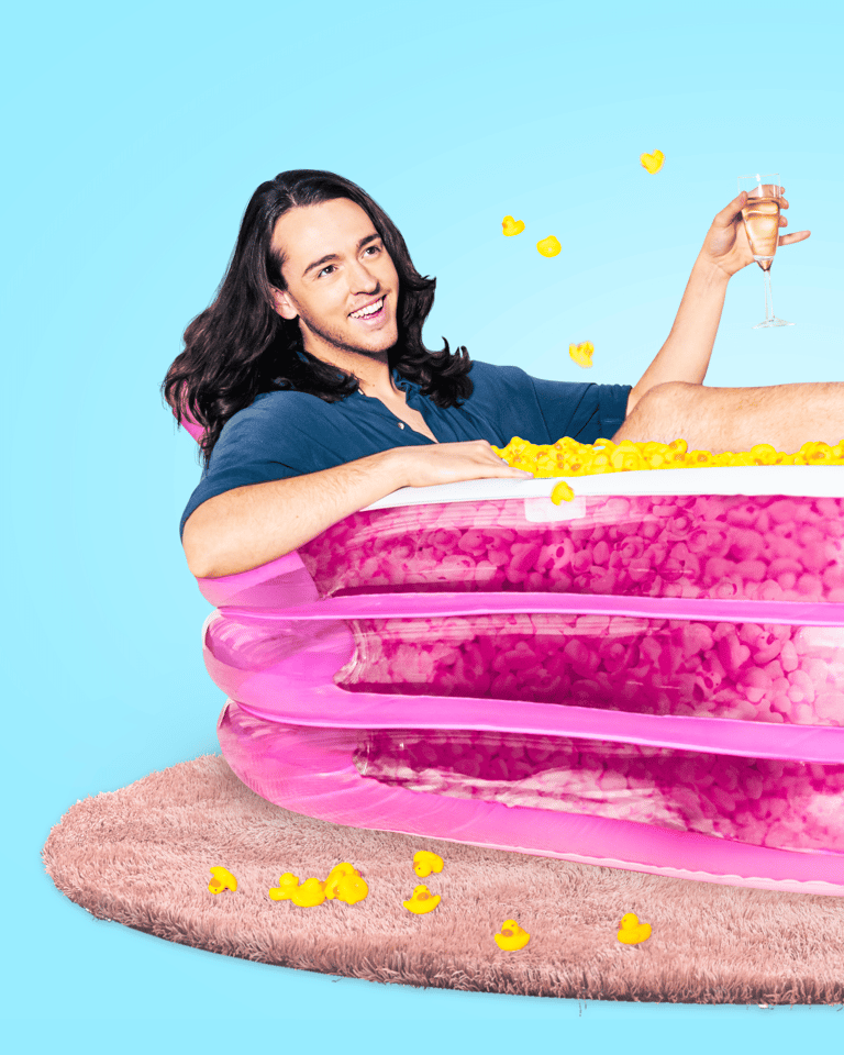 Person with long dark hair holding stacked pink inflatable rings with yellow balls floating against a bright blue background.
