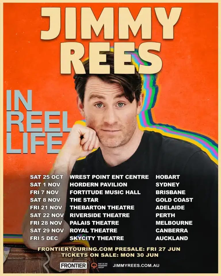Man with dark hair pointing at camera on bright orange poster for comedy show "Jimmy Rees: In Reel Life" with tour dates listed.