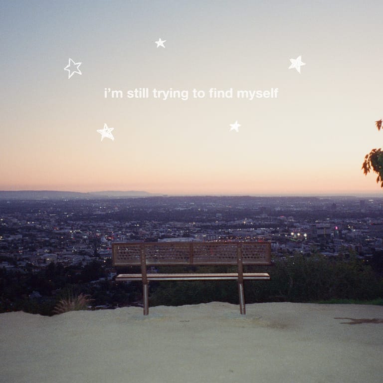 Empty bench overlooking a sprawling city at dusk with white stars and introspective text overlaid.