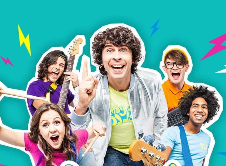 Five young musicians pose playfully against a vibrant turquoise background with cartoon-style lightning bolts and hand gestures.