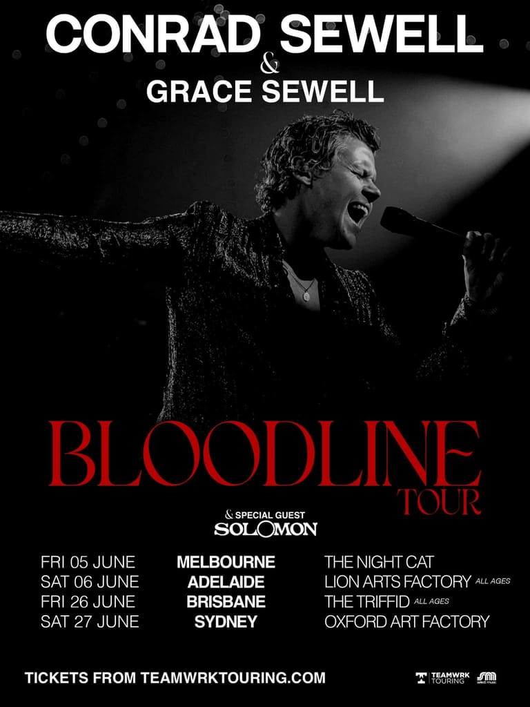 Male performer singing into microphone against dark background during Bloodline Tour promotional material.