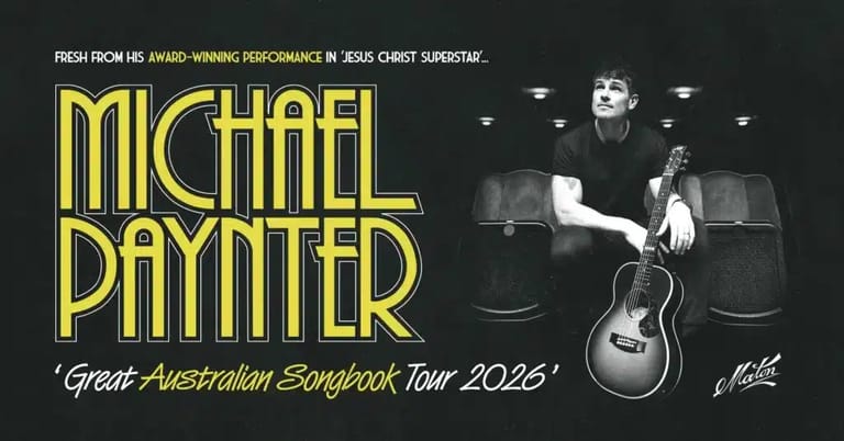 Musician Michael Paynter seated with acoustic guitar against dark backdrop, yellow text promoting Great Australian Songbook Tour 2026.