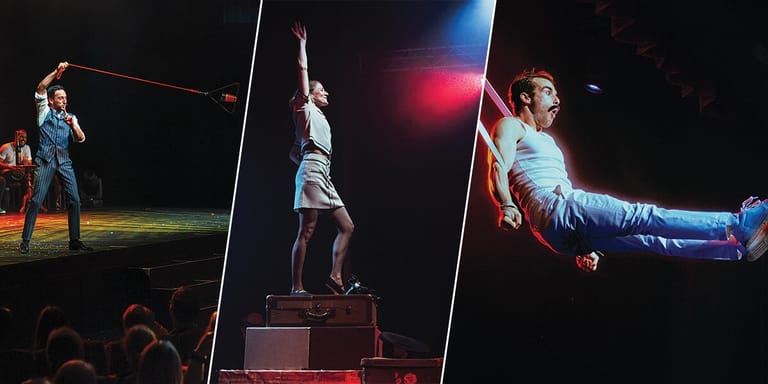 Acrobat suspended mid-air during a circus or theatrical performance with coloured stage lighting.