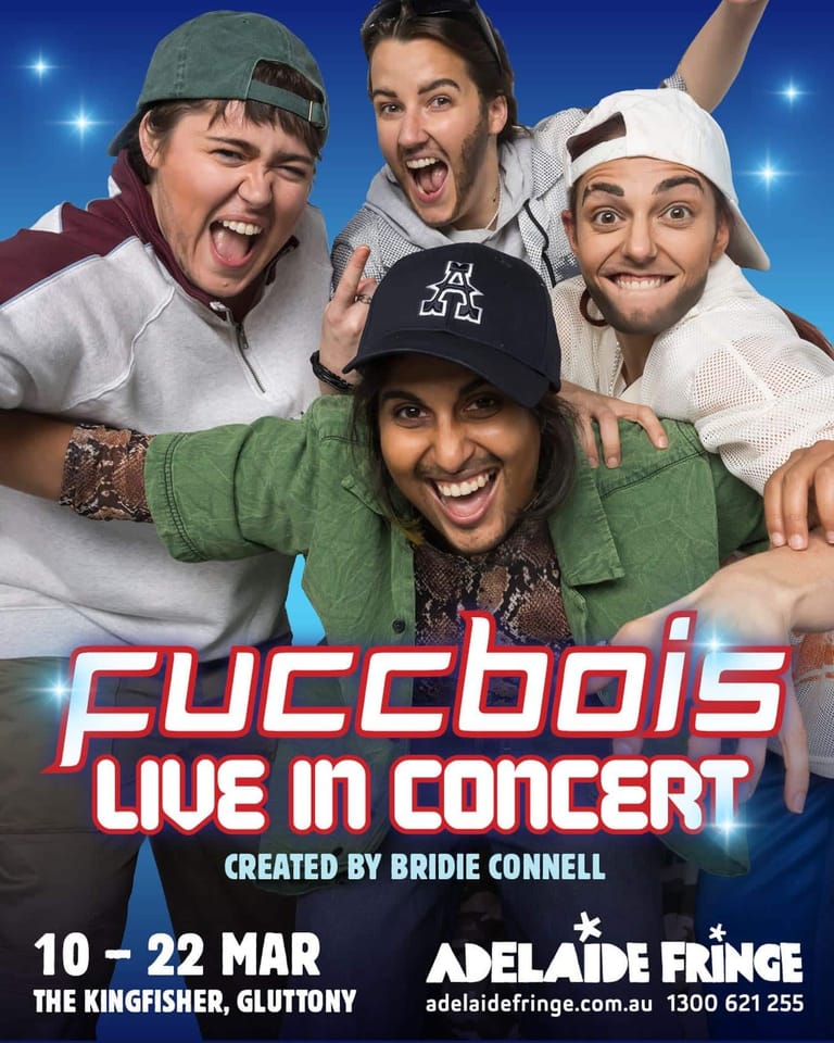 Four performers pose together smiling against a blue starlit background, wearing casual caps and colourful clothing, with neon text reading "Fuccbois Live in Concert" below.