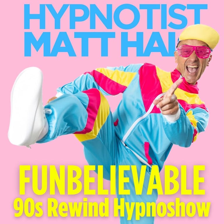 Hypnotist in vibrant 90s-style costume with yellow cap and sunglasses poses energetically against pink background.