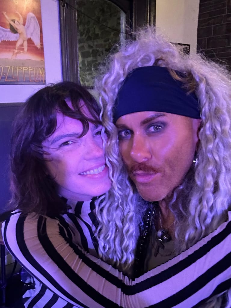 Two performers with long wavy hair pose together under purple stage lighting during the Pierce Brothers 2026 Moonrise Album Tour.