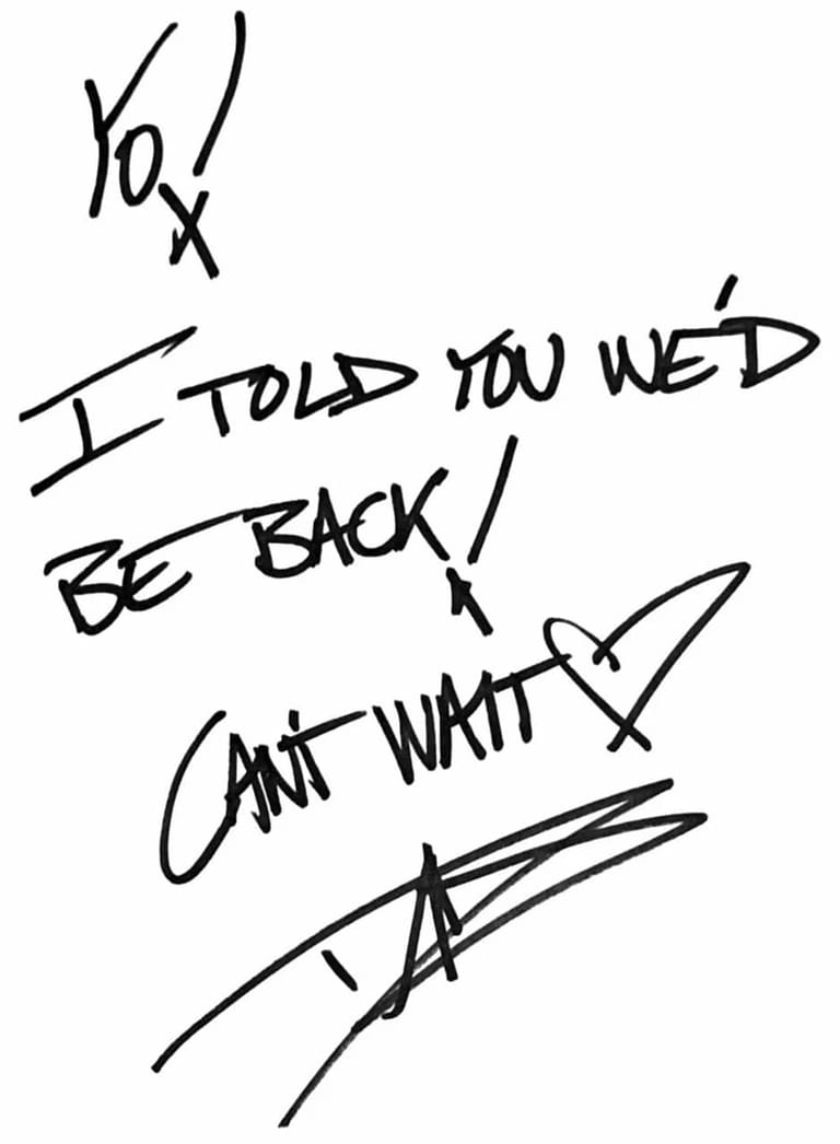 Handwritten text reading "I told you we'd be back / can't wait" with signatures and sketch marks on white background.