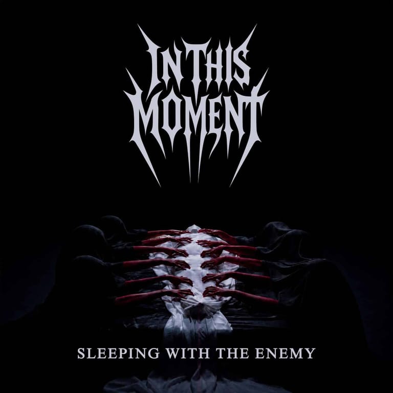 In This Moment band logo above skeletal ribcage imagery with "Sleeping with the Enemy" album title.