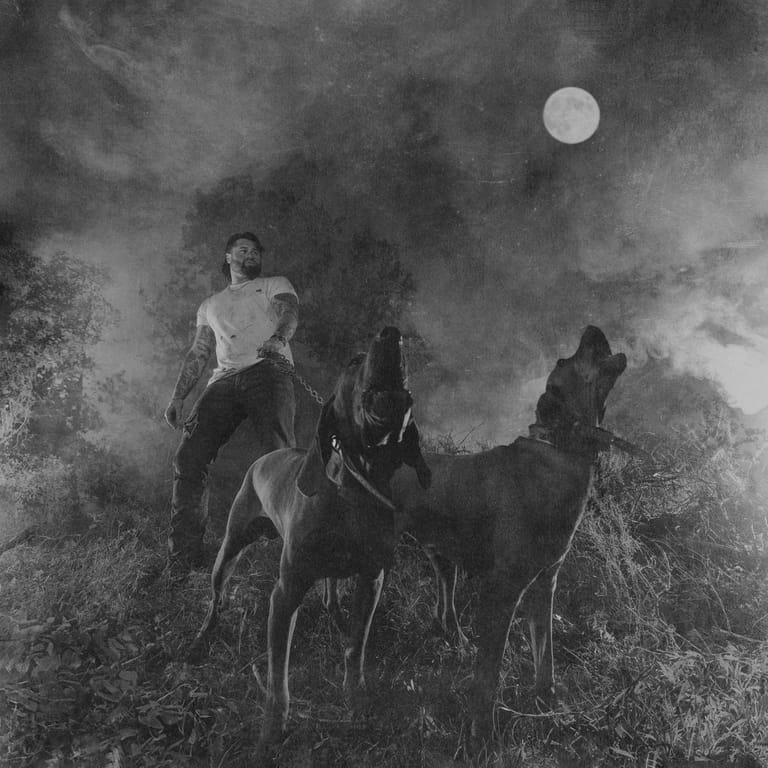 Figure on horseback beneath a full moon in a misty, atmospheric black and white landscape.