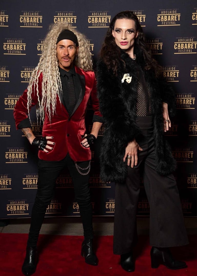 Two performers in elegant evening wear pose on the red carpet at the Adelaide Cabaret Festival opening gala.