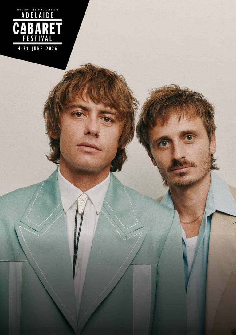 Two musicians in pastel suits pose against a neutral background at Adelaide Cabaret Festival.