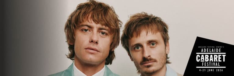 Two men with shoulder-length hair pose against a white background beside an Adelaide Cabaret Festival logo.