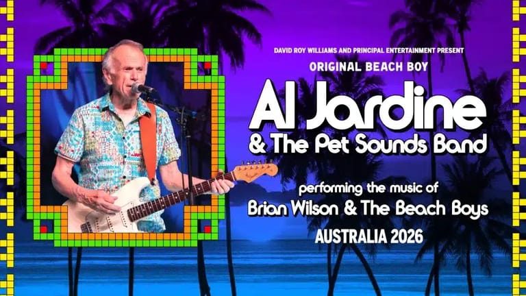 Male musician in patterned shirt playing guitar on stage with purple lighting during Al Jardine & The Pet Sounds Band performance.