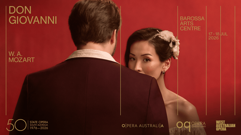 Two performers in period costume face each other against a red backdrop for a Don Giovanni opera production.