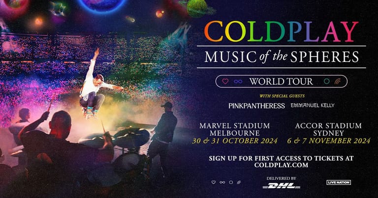 Coldplay perform on stage bathed in vibrant purple and blue lighting during their Music of the Spheres World Tour.