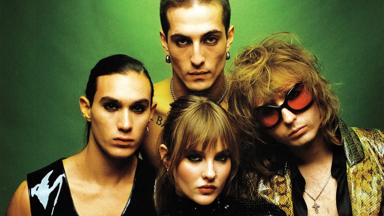 Four members of Maneskin posed against a green and yellow gradient background in rock band styling.